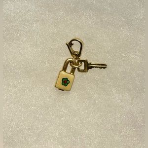 14k yellow gold enamel lock and key charm.